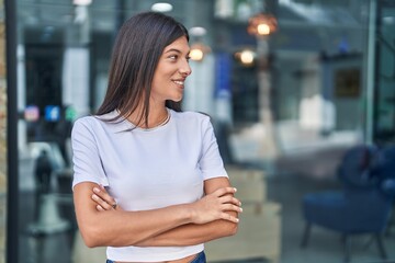 Poster - Young beautiful hispanic woman standing with arms crossed gesture at street