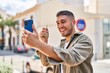 © Krakenimages.com - Young hispanic man holding key of new home make selfie by the smartphone at street