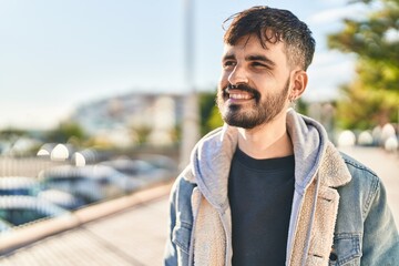 Sticker - Young hispanic man smiling confident looking to the side at street