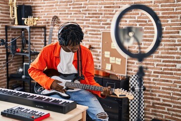 Poster - African american man artist having electrical guitar online lesson at music studio