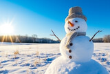 Fototapeta Na sufit - Snowman in snowy field under a clear blue sky background 