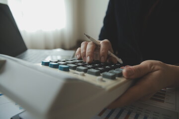 Unrecognizable businessman using calculator