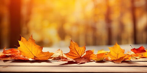 Wall Mural - Beautiful orange leaves on a wooden table in the autumn park. Natural autumn background with blur