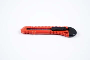 red utility knife on a white background