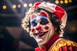 Portrait happy joyful smiling laughing clown circus jester joker man guy male fun happiness carnival make-up red nose actor charismatic face humor playful entertainer comedian artist looking at camera