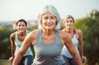 © Romana - many grown-up mature female adults with silver hair doing sports outside. Athletic training and bodies in old age. Middle-aged women preparing for a running long-distance competition while having fun