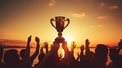 Canvas Print - Victorious team triumphs under sunset with trophy and numerous silhouetted hands