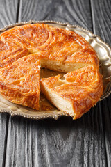 Wall Mural - Kouign-amann is a sweet Breton cake made with laminated dough closeup on the plate on the table. Vertical