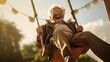 Funny and smiling elderly man of about 90 has fun on the swing, radiating joy and happiness. 
