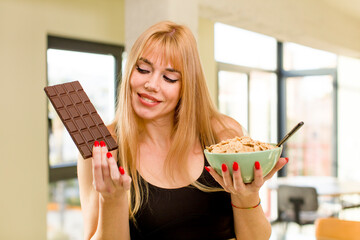 young pretty woman with a chocolate bar at home interior