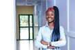 © Boijonell - young African woman standing in a hallway with her arms crossed