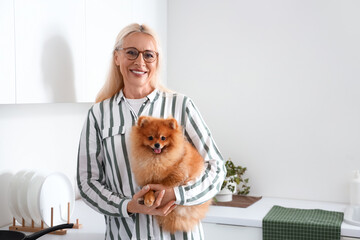 Sticker - Mature woman with Pomeranian dog in kitchen