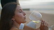 © stockbusters - Sensual woman drinking wine glass beach closeup. Young newlyweds celebrate date