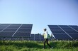 © Serhii - Portrait of Young indian male engineer standing near solar panels, with clear blue sky background, Renewable and clean energy. skill india, copy space.
