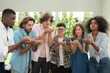 © Wosunan - Group of multiethnic friends having fun at party playing fun blowing colorful paper