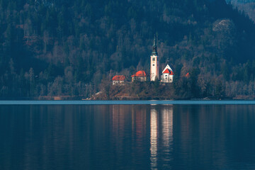 Lake Bled in cold february morning with famous landmark, the Assumption of Maria Church in background