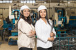 © Niks Ads - Confident female engineers standing at industry plant. engineering concept.