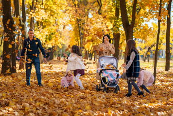 Poster - portrait of a large family with children in an autumn city park, happy people walking together, playing and throwing yellow leaves, beautiful nature, bright sunny day