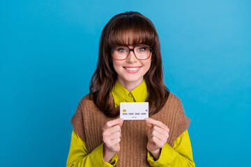 Poster - Photo of funky cheerful lady wear brown vest spectacles holding credit card isolated blue color background