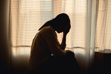 Silhouette Photo Of Young Asian Woman Feeling Upset, Sad, Unhappy Or Disappoint Crying Lonely In Her Room. Young People Mental Health Care Problem Lifestyle Concept.	