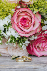 Wall Mural - Beautiful wedding rings close-up macro photography. Bride and groom's wedding rings  beautiful flowers