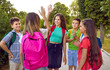 © Studio Romantic - Bunch of children having fun after school. Group of joyful little friends playing outside. Two happy girls standing on a park path with other boys and girls, smiling and giving each other a high five