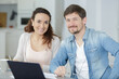 © auremar - portrait of happy couple managing home finances