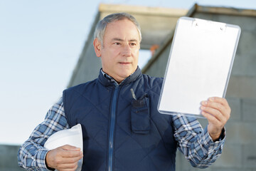 male manager chceking his clipboard