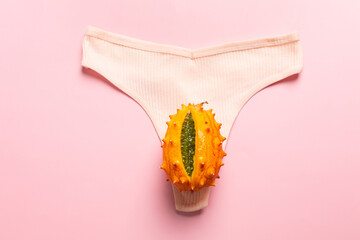 Wall Mural - Exotic fruit in the form of a vagina on women's panties, the concept of the female reproductive system