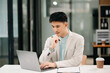 © Nuttapong punna - Young Asian business man working at office with laptop, tablet and taking notes on the paper.