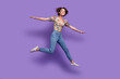 © deagreez - Full body photo of excited pretty lady have good mood jumping arms wings flying isolated on violet color background