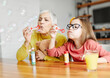 © Lumos sp - child grandparent granddaughter grandmother bubble soap blowing fun together girl grandchild family senior smiling woman female happy adult lifestyle generation childhood togetherness