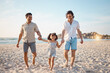 © Davids C/peopleimages.com - Gay couple, summer and holding hands with family at beach for seaside holiday, support and travel. Relax, vacation and love with men and child in nature for lgbtq, happiness and bonding together