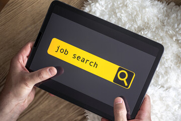 Wall Mural - top view of digital tablet with search job on screen in male hands.