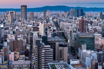 Wall Mural - sunset or sun rise of  Osaka cityscape with Skyline and office building and downtown of Osaka with twilight sky in summer season