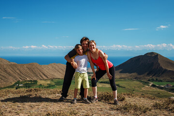 Sticker - Happy family of hikers posing on top of the mountain