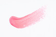 © Tetiana - Light glitter pink paint swatch on white paper background. Pink swatch of lip gloss, cosmetic product stroke gouache, oil paint texture, cosmetic or beauty product texture.