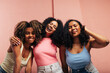 © Artem Varnitsin - Three laughing females with curly hair having fun and looking at camera