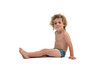 side view of a boy in underpants sitting on the floor looking away on white background (3 year old)