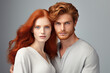 © yuliachupina - Portrait of beautiful redhead couple isolated on grey studio background. AI generated