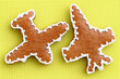 Leinwandbild Motiv Gingerbreads in a shape of airplane decorated with white icing, bright yellow background