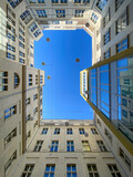 Fototapeta Miasto - Low angle view courtyard of apartment block