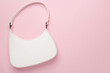 © Liami - Trendy woman bag on color background, top view