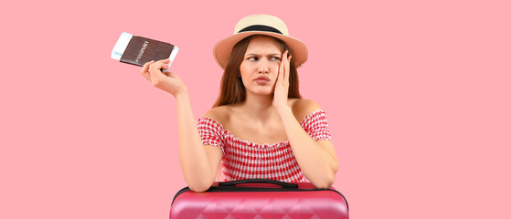 Sticker - Displeased female tourist with packed suitcase, passport and ticket on pink background