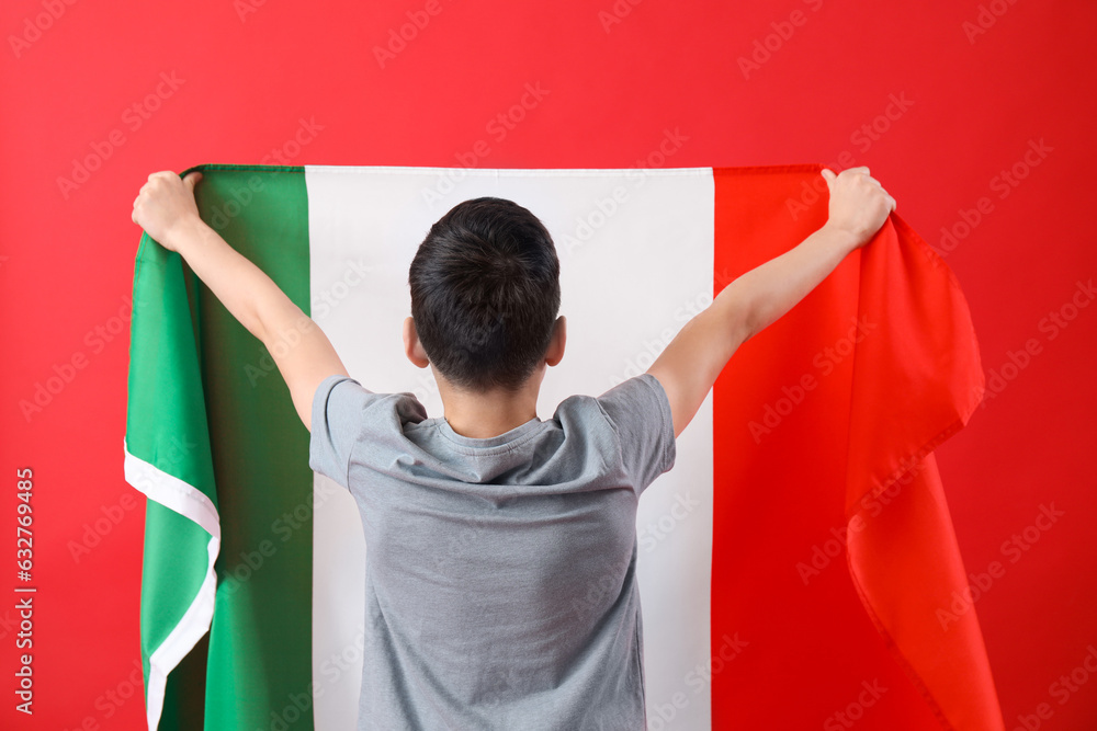 Little boy with flag of Italy on red background, back view