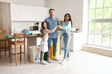 Wall Mural - Family putting hands together while sorting garbage in kitchen