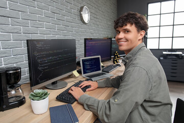 Male programmer working with computer at table in office