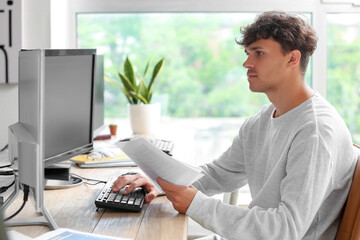 Canvas Print - Male programmer working with computer at table in office