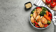 © Uuganbayar - Delicious cooked chicken and vegetables on grey marble table, flat lay with space for text. Healthy meals from air fryer
