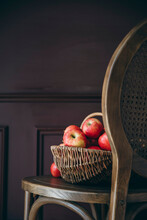 Apples In A Basket Against A Dark Background
